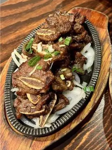 Asian-Cuisine-Noodles-&-Dumplings-Chinese-restaurant-Fried-Lamb-Chops-Mahopac Fried Lamb Chops - Tender fried lamb chops garnished with scallions, served on a bed of onions at Asian Cuisine Noodles & Dumplings, a Chinese restaurant in Mahopac