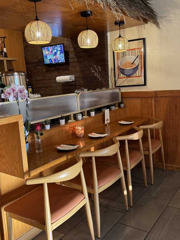 Asian-Cuisine-Noodles-&-Dumplings-Chinese-restaurant-Cozy-Dining-Nook-Mahopac Cozy Dining Nook - Wooden setup, hanging lamps & TV for a snug vibe at Asian Cuisine Noodles & Dumplings, a Chinese restaurant in Mahopac